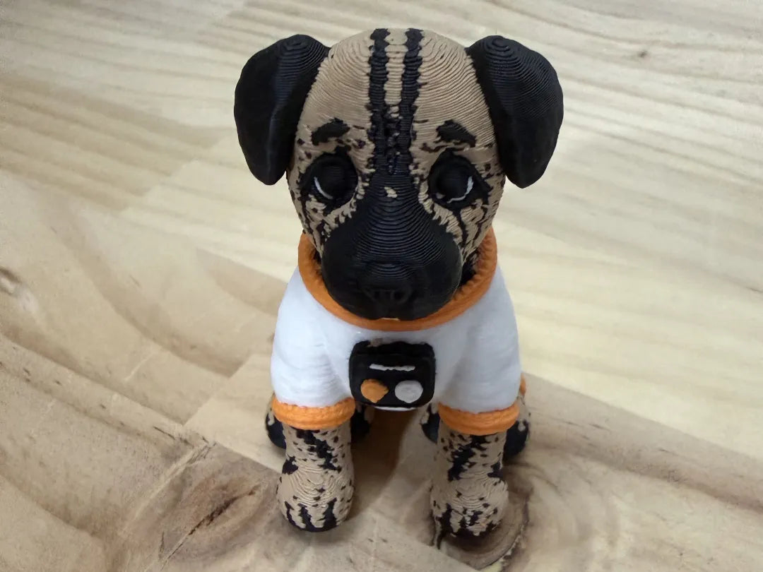 Front view of Astro Dog in a white astronaut-style suit with orange trim