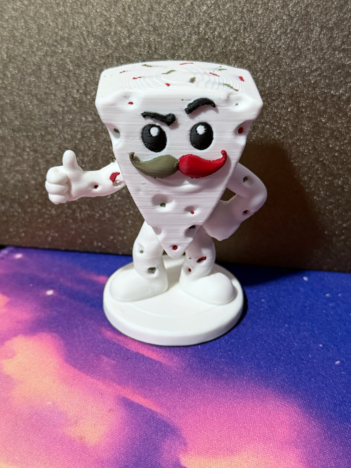 Cheezy Pepper Jack figure with colorful pepper flecks and a curled mustache