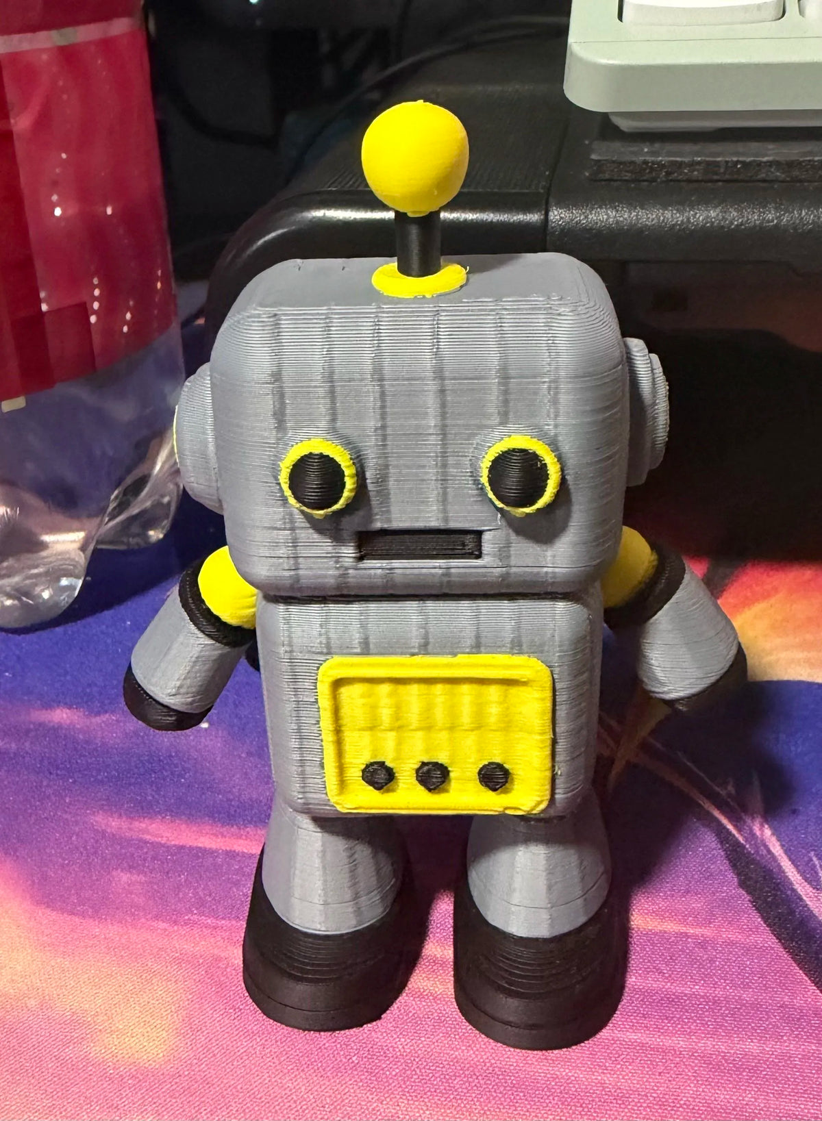 Gray Cheezy Robot figure with yellow accents, antenna, and front control panel