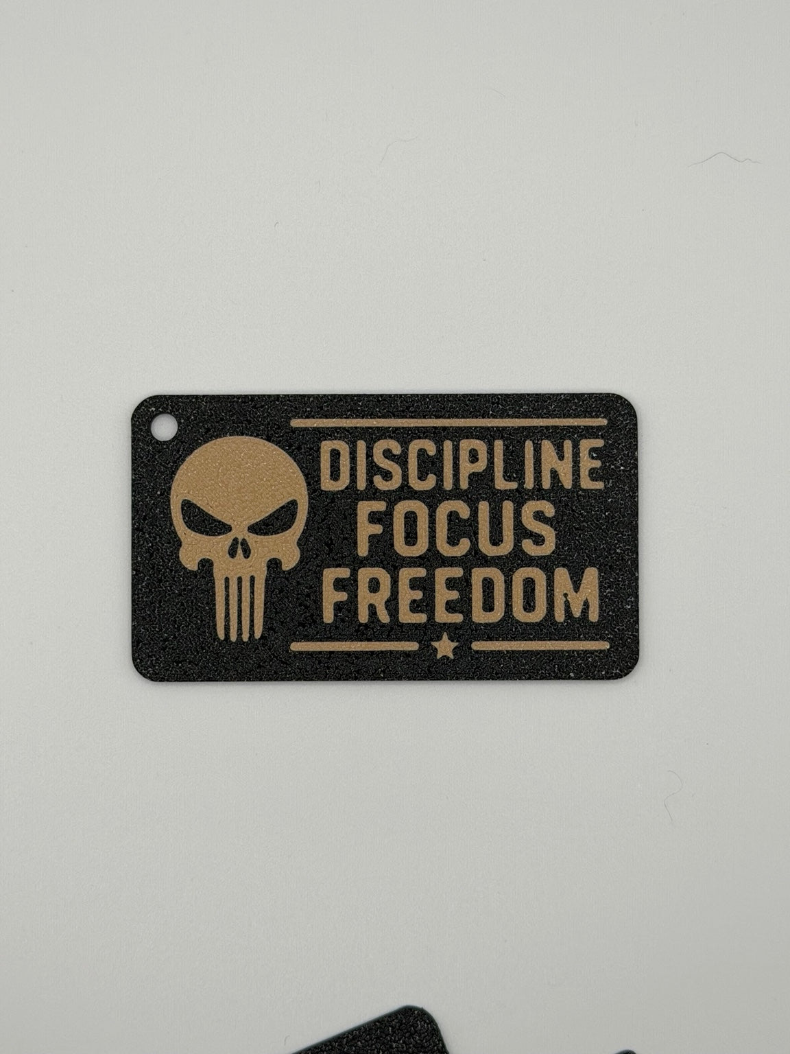 3D printed Discipline Focus Freedom military-style keychain in black and tan