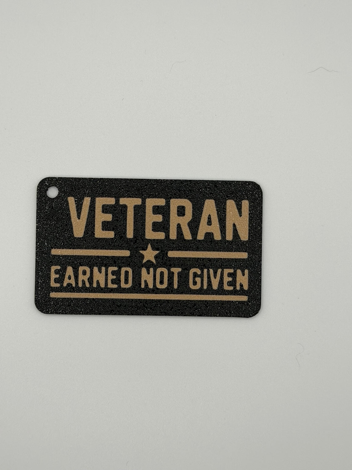 3D printed Veteran Earned Not Given keychain in black and tan