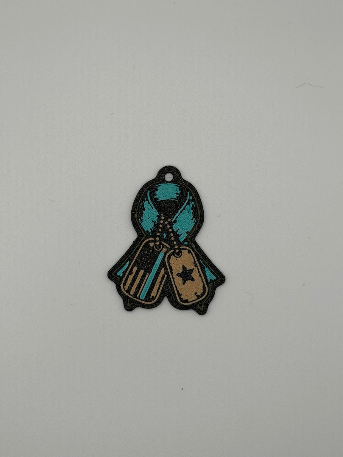 3D printed veteran awareness ribbon keychain with dog tags in black, tan, and teal