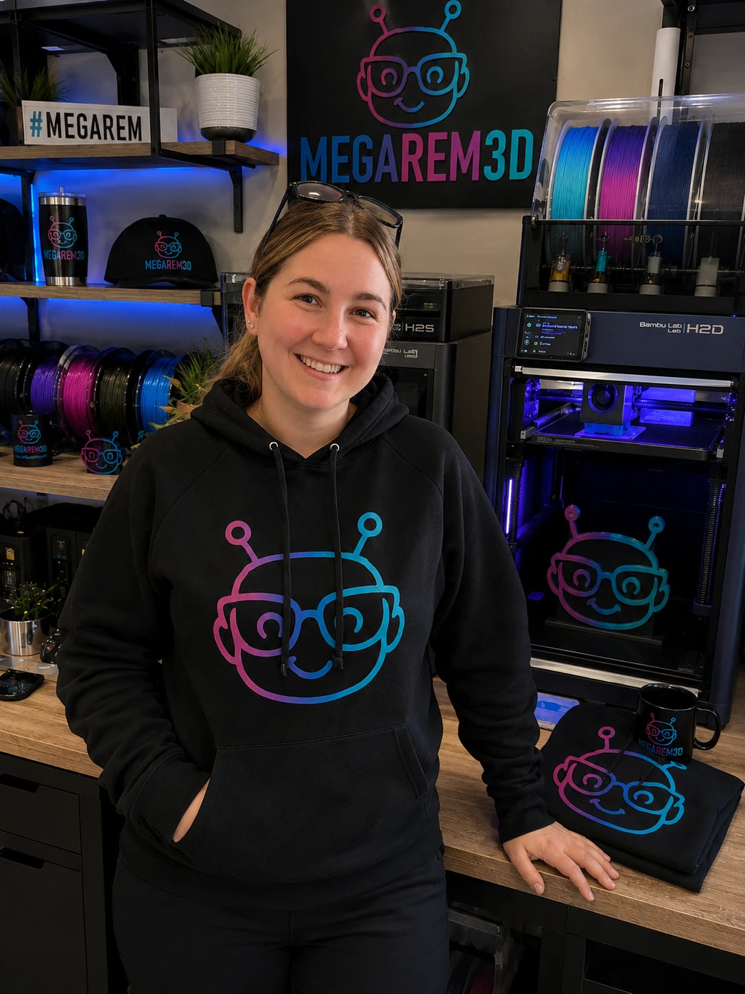 Megan in the MegaRem3D workshop with her 3D printers and custom creations